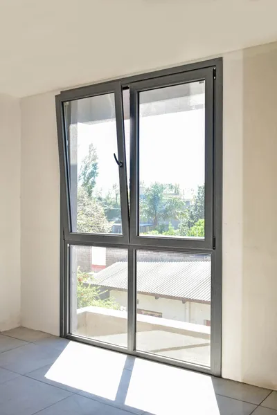 Ventana osclibatiente de aluminio anodizado con dos paños fijos inferiores