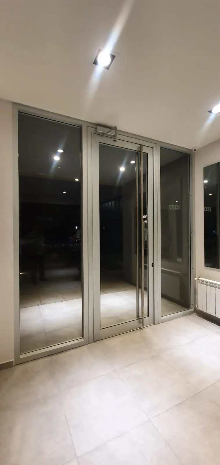Puerta ventana de aluminio anodizado en el interior de un departamento