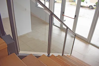 Baranda de cristal junto a la escalera y los paños vidriados de la oficina